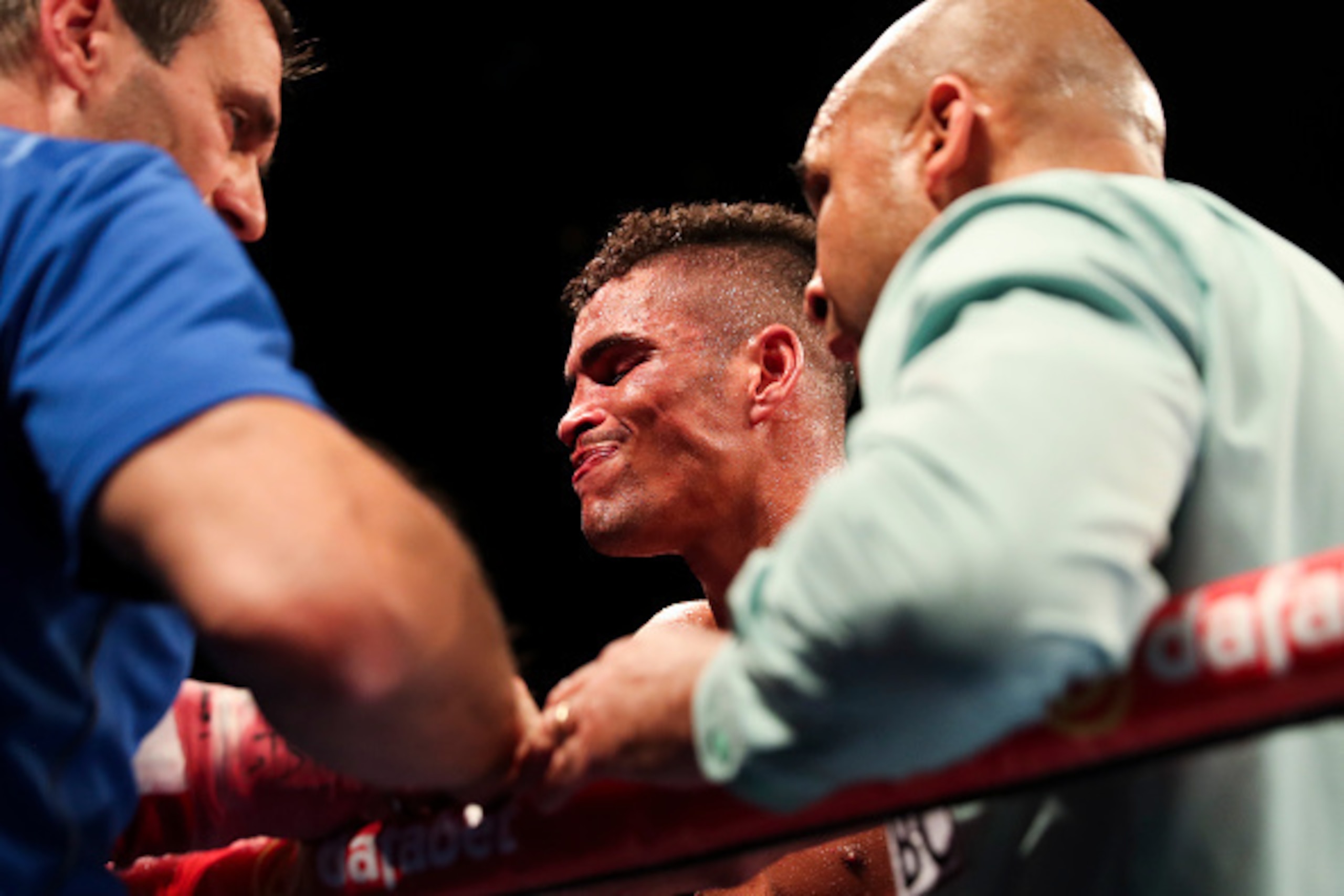 BIRMINGHAM, ENGLAND - OCTOBER 22:  Anthony Ogogo Of England is puled out by his trainer Tony Sims during the 8th round against Craig Cunningham Of England during their WBC International Middleweight title fight at Barclaycard Arena on October 22, 2016 in 