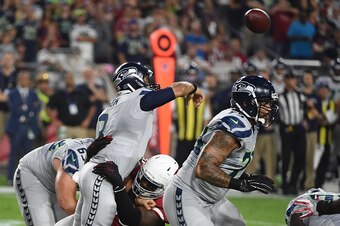 GLENDALE, AZ - OCTOBER 23:  Quarterback Russell Wilson #3 of the Seattle Seahawks is tackled by Arizona Cardinals defense while making a pass during the first half of the NFL game at University of Phoenix Stadium on October 23, 2016 in Glendale, Arizona. 