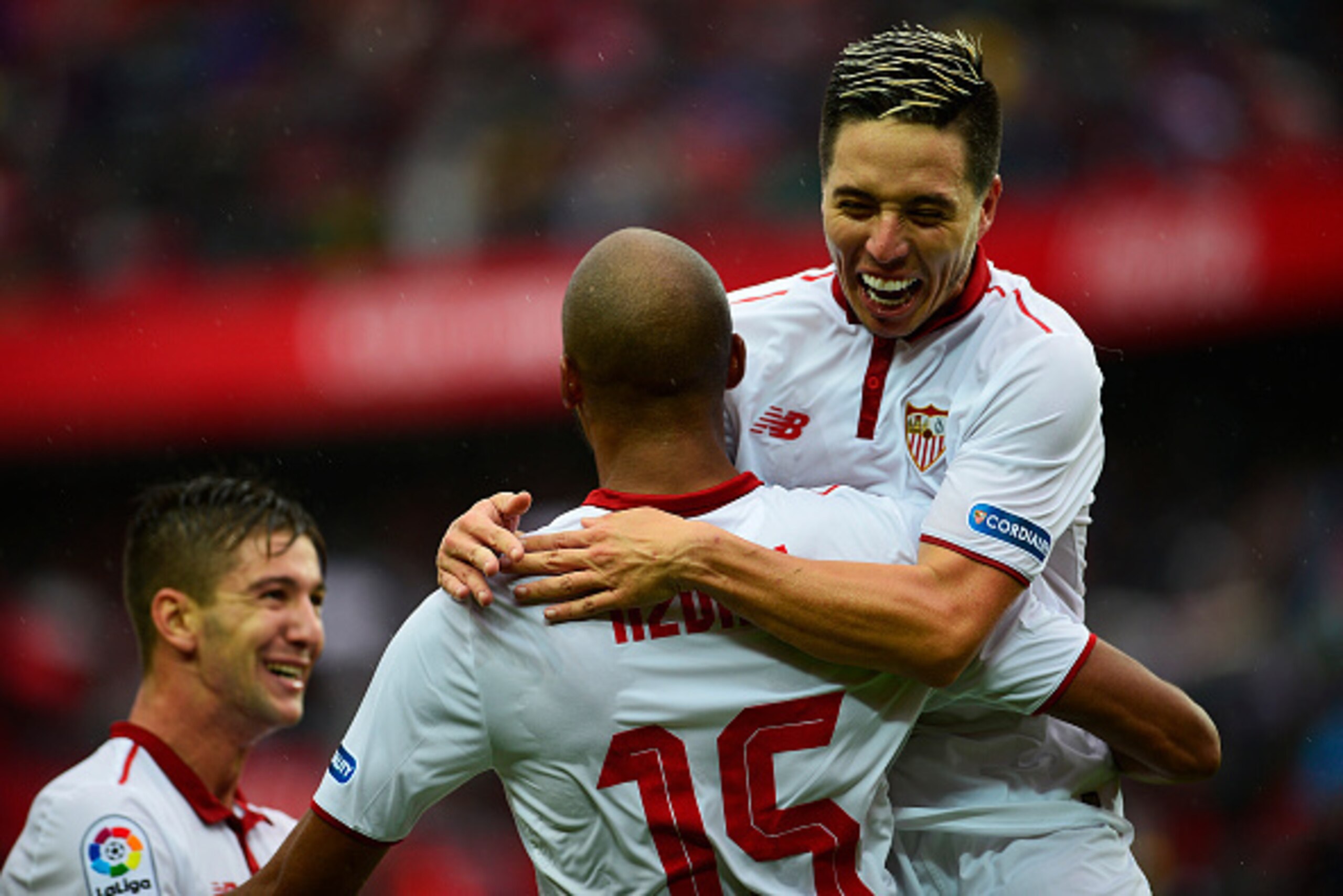 Sevilla's French midfielder Steven N'Zonzi (back) celebrates a goal with Sevilla's French midfielder Samir Nasri (R) during the Spanish league football match between Sevilla FC and Club Atletico de Madrid at the Ramon Sanchez Pizjuan stadium in Sevilla on