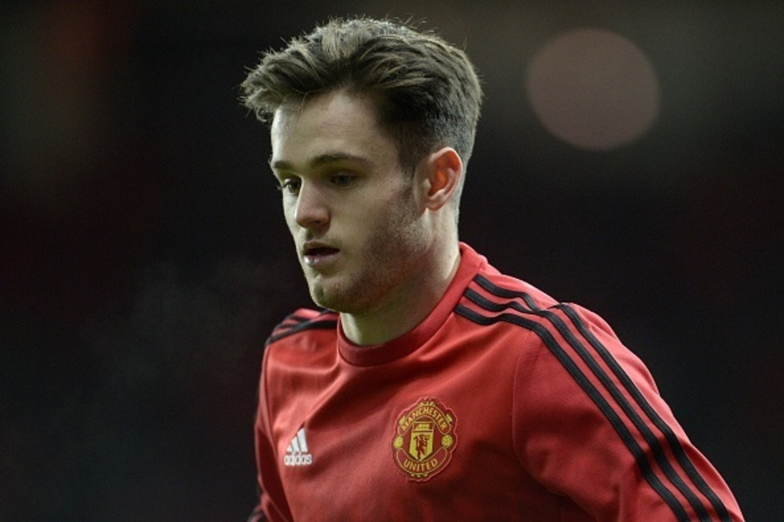 Manchester United's English defender Joe Riley warms up ahead of the UEFA Europa League round of 32, second leg football match between Manchester United and and FC Midtjylland at Old Trafford in Manchester, north west England, on February 25, 2016. 
 / AF