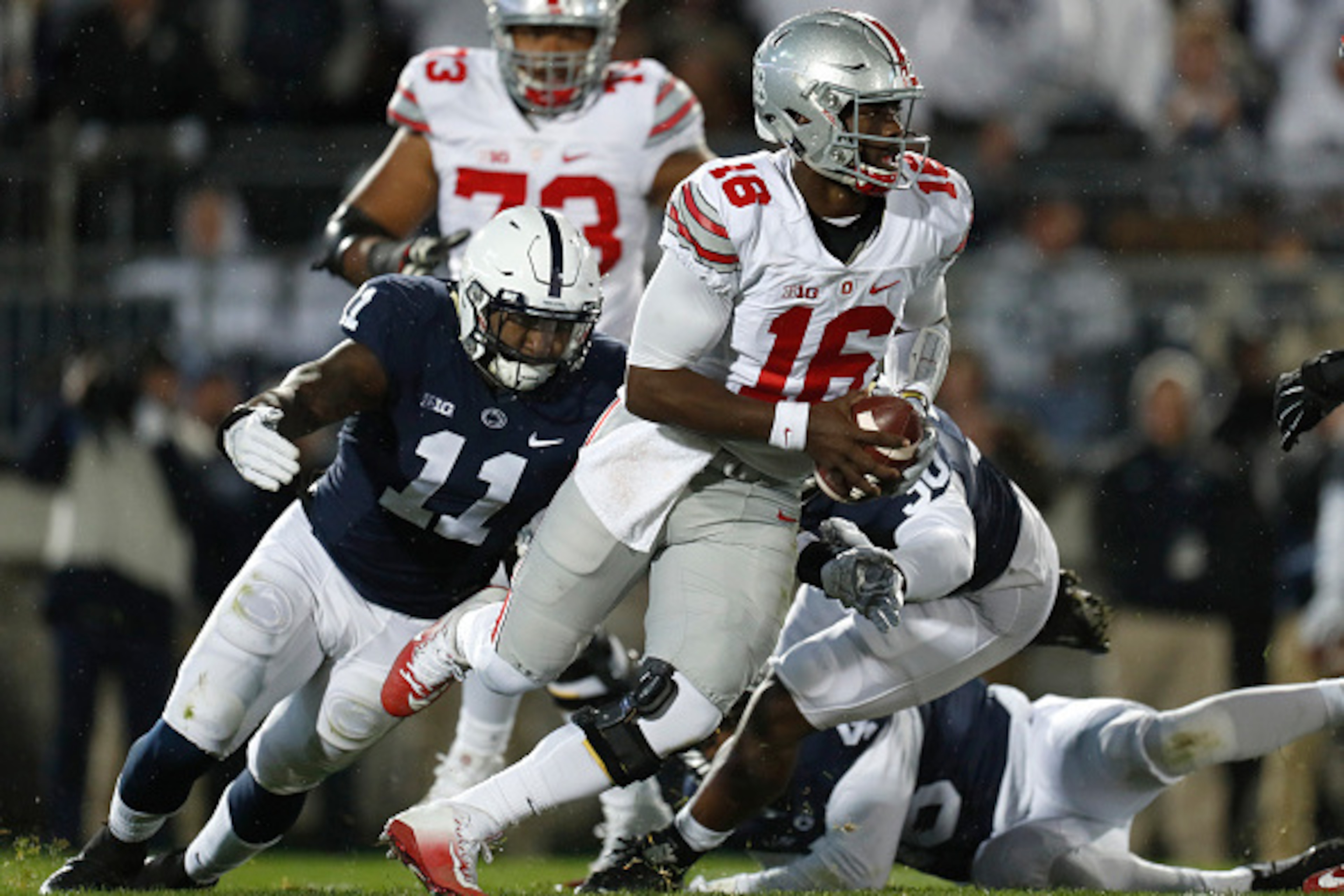 STATE COLLEGE, PA - OCTOBER 22: J.T. Barrett #16 of the Ohio State Buckeyes is hurried by Brandon Bell #11 of the Penn State Nittany Lions in the first half during the game on October 22, 2016 at Beaver Stadium in State College, Pennsylvania. (Photo by STATE COLLEGE, PA - OCTOBER 22: J.T. Barrett #16 of the Ohio State Buckeyes is hurried by Brandon Bell #11 of the Penn State Nittany Lions in the first half during the game on October 22, 2016 at Beaver Stadium in State College, Pennsylvania. (Photo by