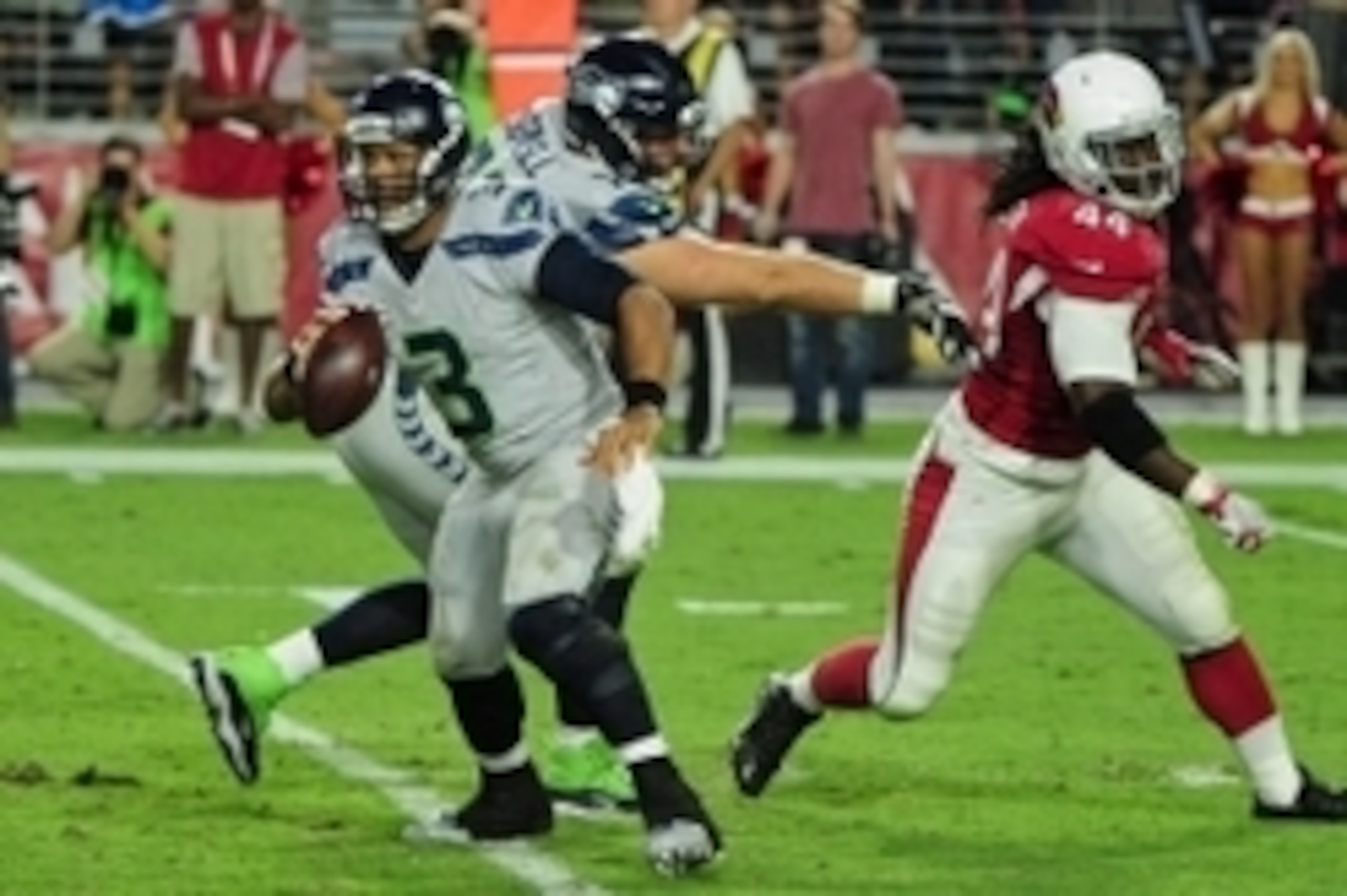 Oct 23, 2016; Glendale, AZ, USA; Seattle Seahawks quarterback Russell Wilson (3) runs from Arizona Cardinals outside linebacker Markus Golden (44) as offensive tackle Bradley Sowell (78) defends during the second half at University of Phoenix Stadium. Man