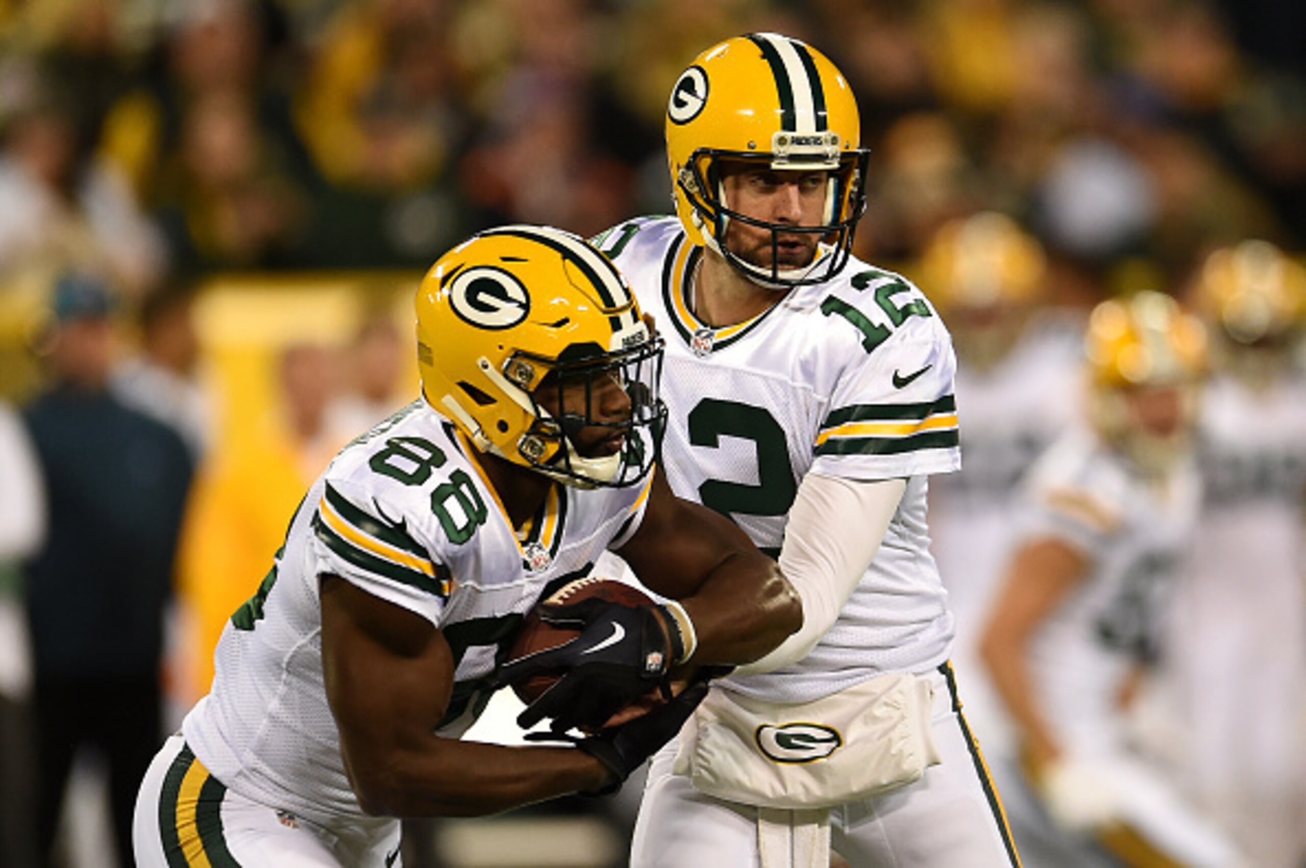GREENBAY, WI - OCTOBER 20: Quarterback Aaron Rodgers #12 of the Green Bay Packers hands the ball off to teammate wide receiver Ty Montgomery #88 against the Chicago Bears in the first quarter at Lambeau Field on October 20, 2016 in Green Bay, Wisconsin. (