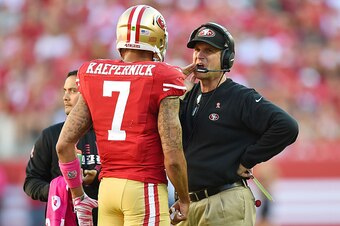 SANTA CLARA, CA - OCTOBER 05:  Head coach Jim Harbaugh of the San Francisco 49ers talks with quarterback Colin Kaepernick #7 during a timeout late in the fourth quarter against the Kansas City Chiefs at Levi's Stadium on October 5, 2014 in Santa Clara, Ca