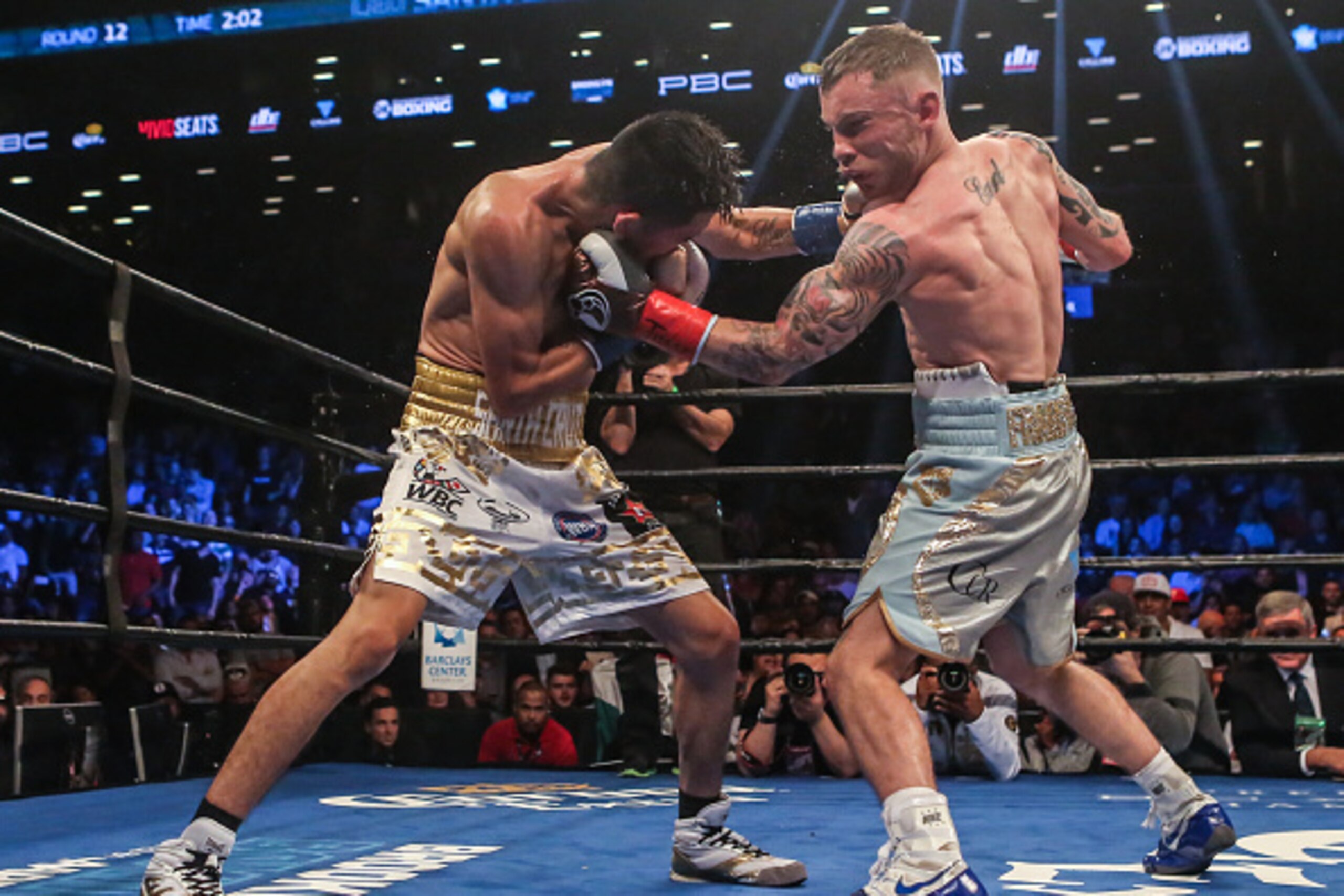 NEW YORK, NY - JULY 30:  Leo Santa Cruz of Mexico (gold trunks) fights Carl Frampton of Northern Ireland (blue trunks) during their  12 round WBA Super  featherweight championship  bout  at Barclays Center on July 30, 2016 in the Brooklyn borough in New Y