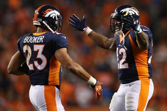DENVER, CO - OCTOBER 24:  Running back Devontae Booker #23 and running back C.J. Anderson #22 of the Denver Broncos celebrate a score in the second half of the game against the Houston Texans at Sports Authority Field at Mile High on October 24, 2016 in D