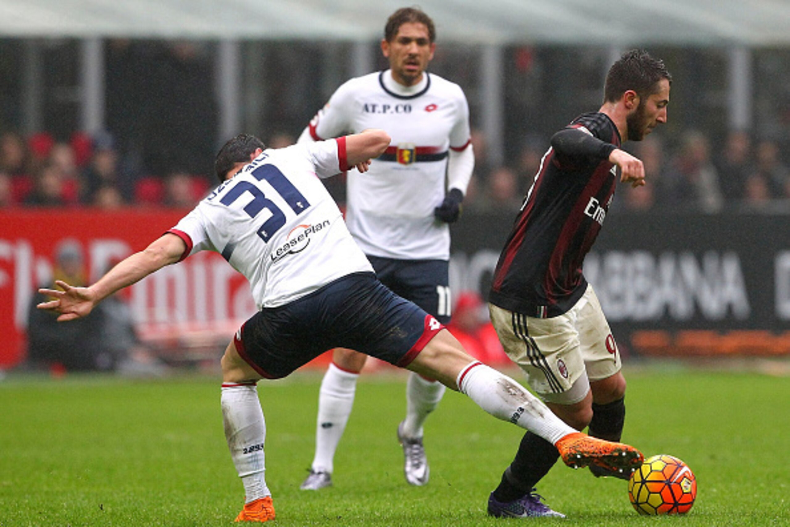 MILAN, ITALY - FEBRUARY 14:  Andrea Bertolacci (R) of AC Milan competes for the ball with Blerim Dzemaili (L) of Genoa CFC during the Serie A match between AC Milan and Genoa CFC at Stadio Giuseppe Meazza on February 14, 2016 in Milan, Italy.  (Photo by M