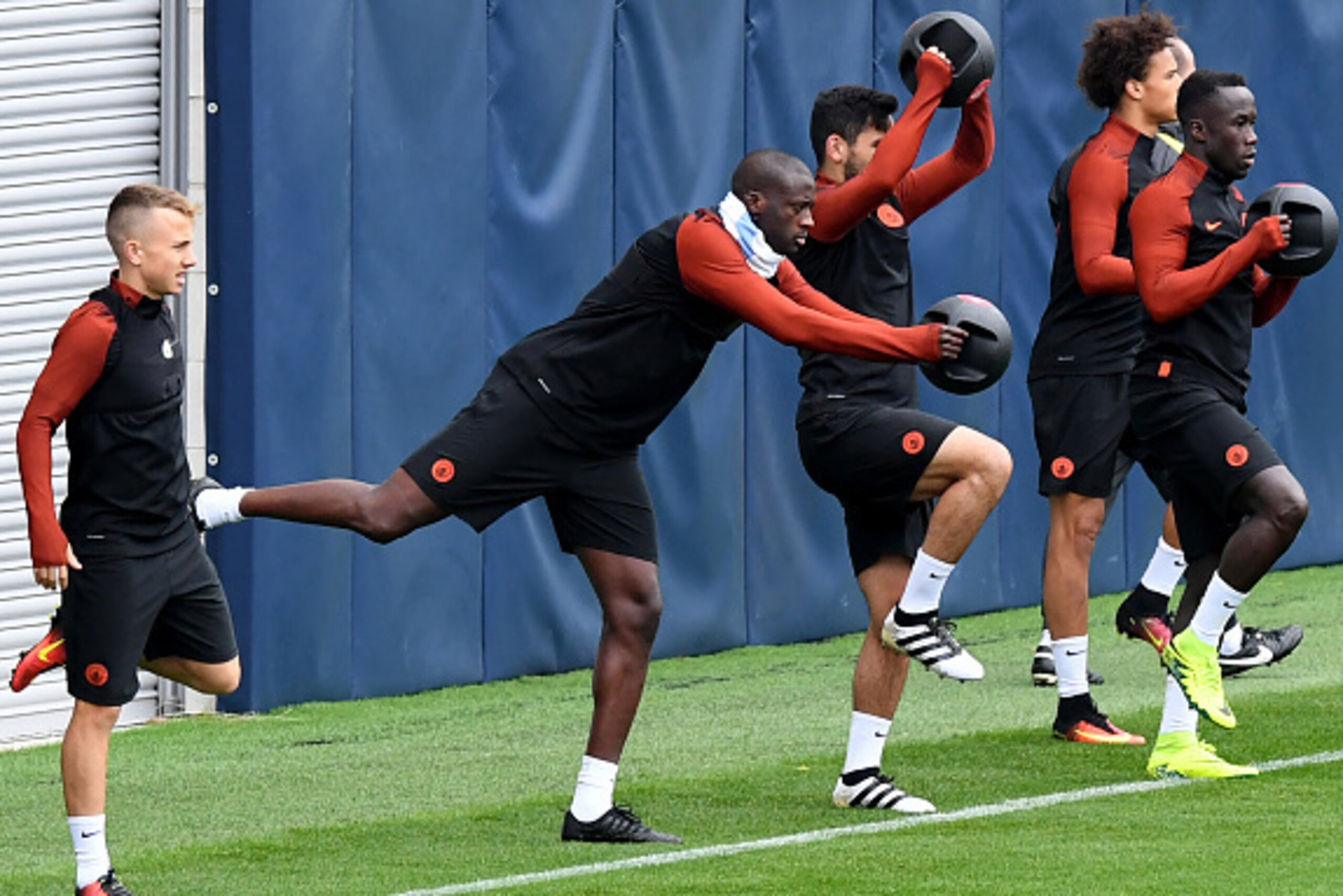 Manchester City's Ivorian midfielder Yaya Toure 92nd (2nd L) and teammates take part in a team training session at Manchester City Football Academy Campus in Manchester, north west England, on September 27, 2016.
Manchester City will play against Celtic i