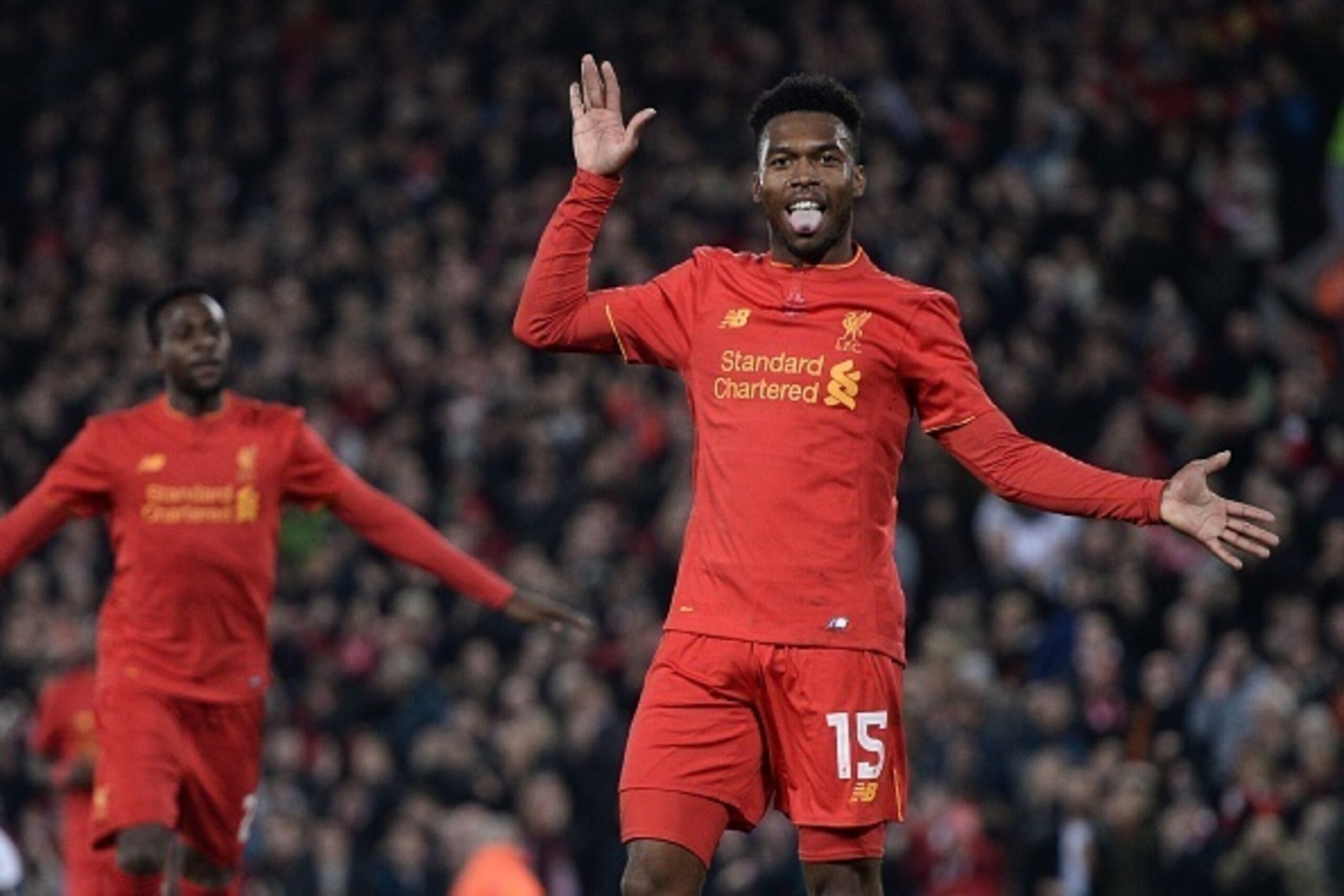 Liverpool's English striker Daniel Sturridge (R) celebrates after scoring their second goal during the EFL (English Football League) Cup fourth round match between Liverpool and Tottenham Hotspur at Anfield in Liverpool north west England on October 25, 2