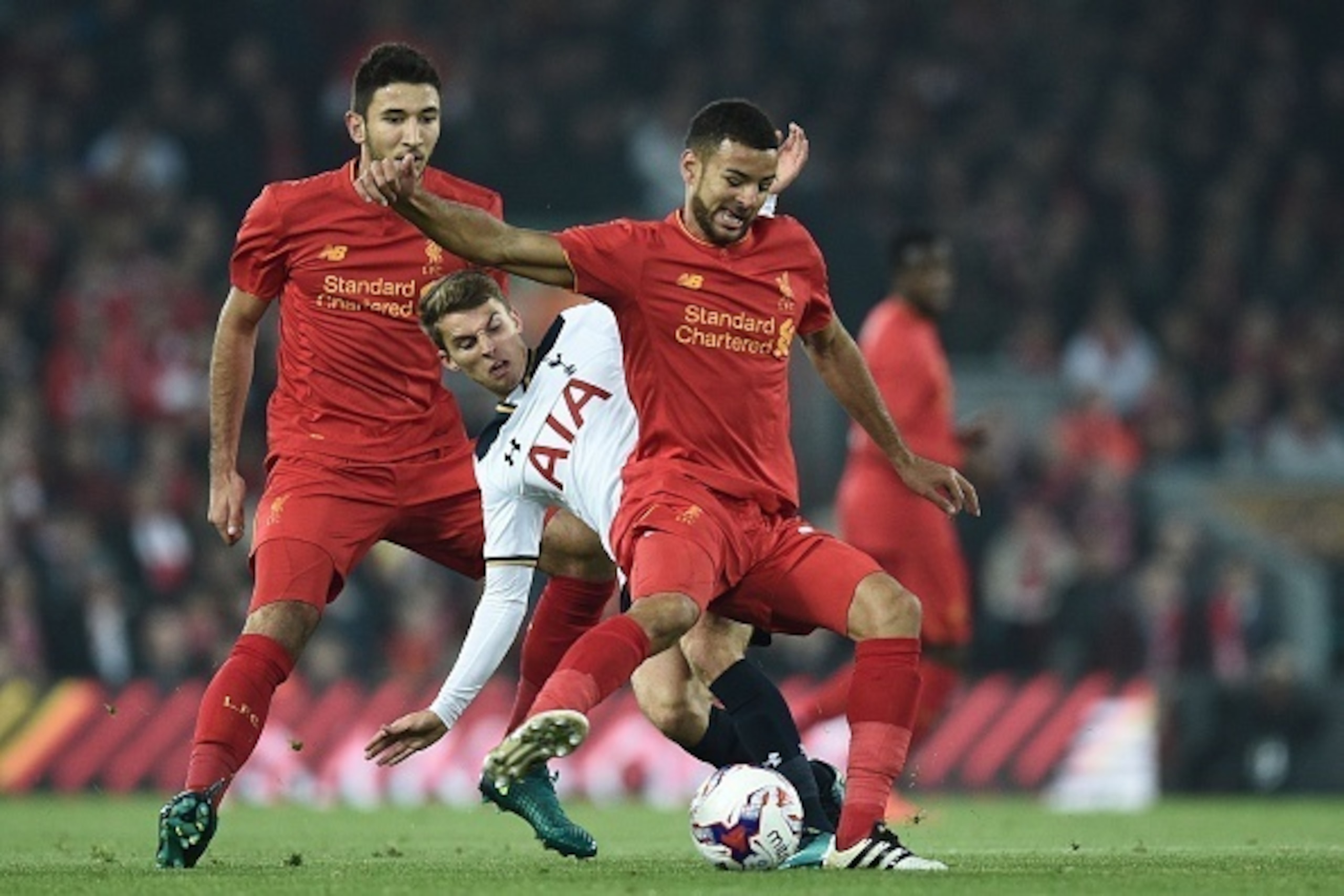 Liverpool's English defender Kevin Stewart (R) vies with Tottenham Hotspur's English midfielder Tom Carroll during the EFL (English Football League) Cup fourth round match between Liverpool and Tottenham Hotspur at Anfield in Liverpool north west England 