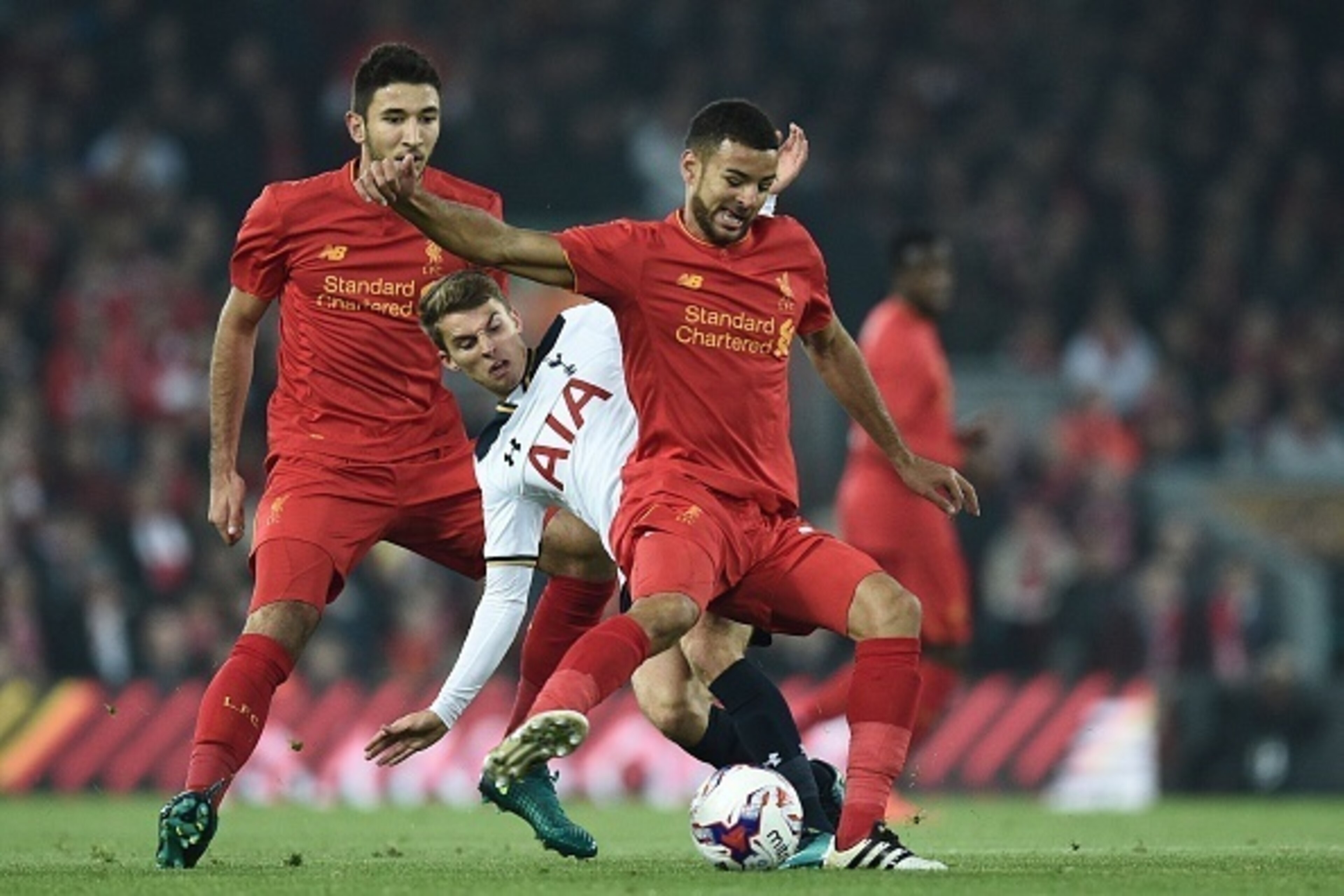 Liverpool's English defender Kevin Stewart (R) vies with Tottenham Hotspur's English midfielder Tom Carroll during the EFL (English Football League) Cup fourth round match between Liverpool and Tottenham Hotspur at Anfield in Liverpool north west England 