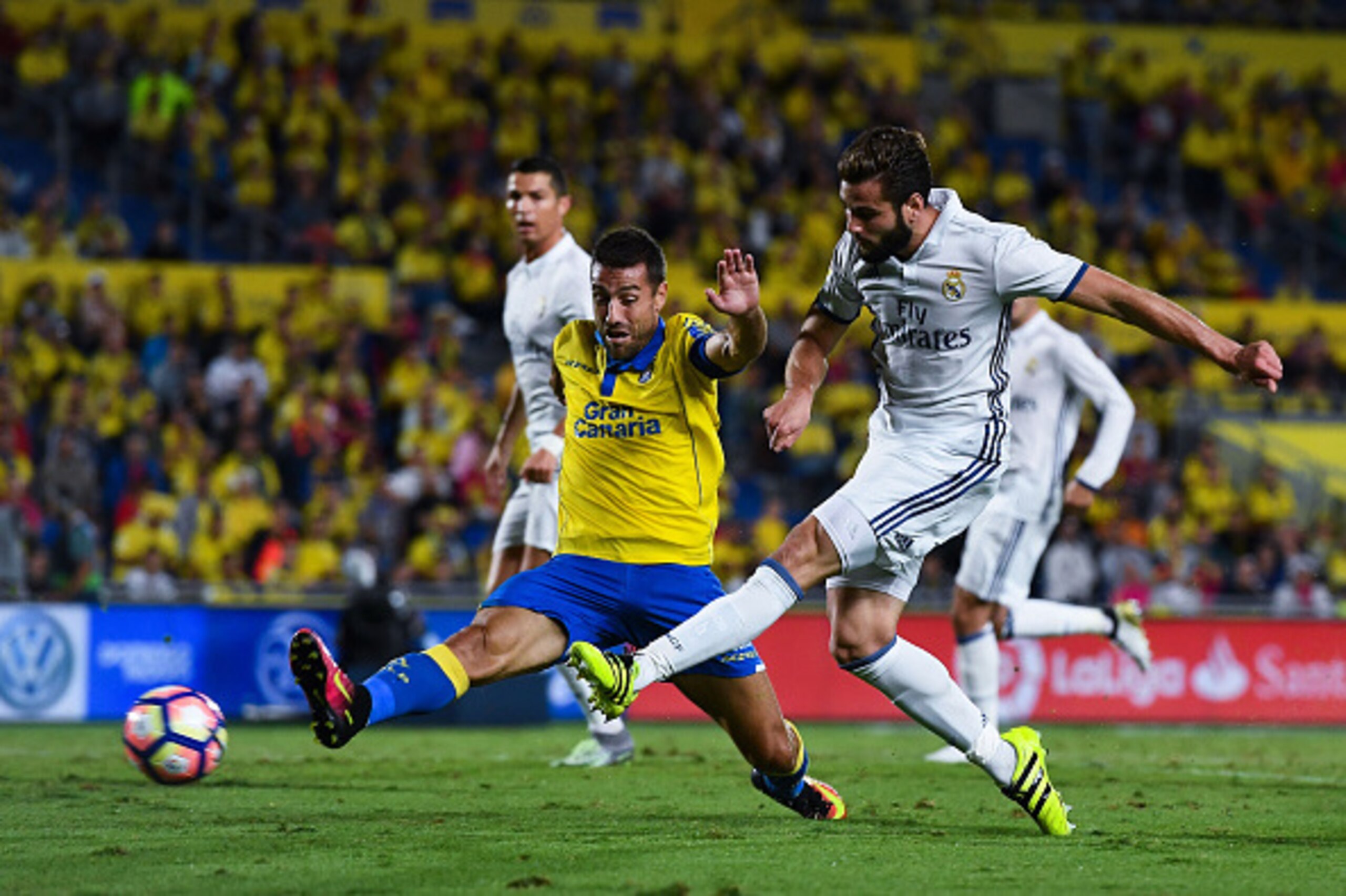 LAS PALMAS, SPAIN - SEPTEMBER 24:  Nacho Fernandez of Real Madrid CF shoots towards goal under a challenge by David Garcia of UD Las Palmas during the La Liga match between UD Las Palmas and Real Madrid CF on September 24, 2016 in Las Palmas, Spain.  (Pho