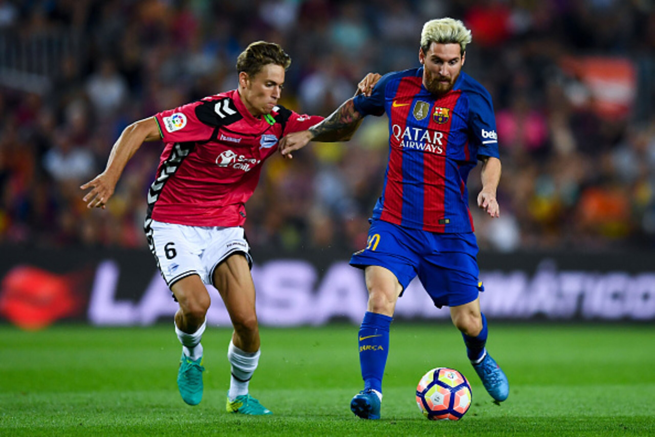 BARCELONA, SPAIN - SEPTEMBER 10:  Lionel Messi of FC Barcelona competes for the ball with Marcos Llorente of Deportivo Alaves during the La Liga match between FC Barcelona and Deportivo Alaves at Camp Nou stadium on September 10, 2016 in Barcelona, Spain.