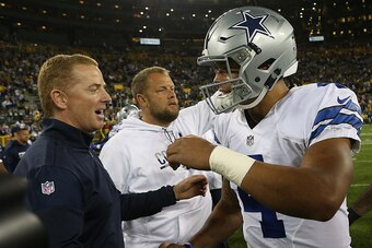 GREEN BAY, WI - OCTOBER 16: Dak Prescott #4 is congratulated by his head coach Jason Garrett of the Dallas Cowboys after defeating the Green Bay Packers at Lambeau Field on October 16, 2016 in Green Bay, Wisconsin. The Dallas Cowboys defeated the Green Ba
