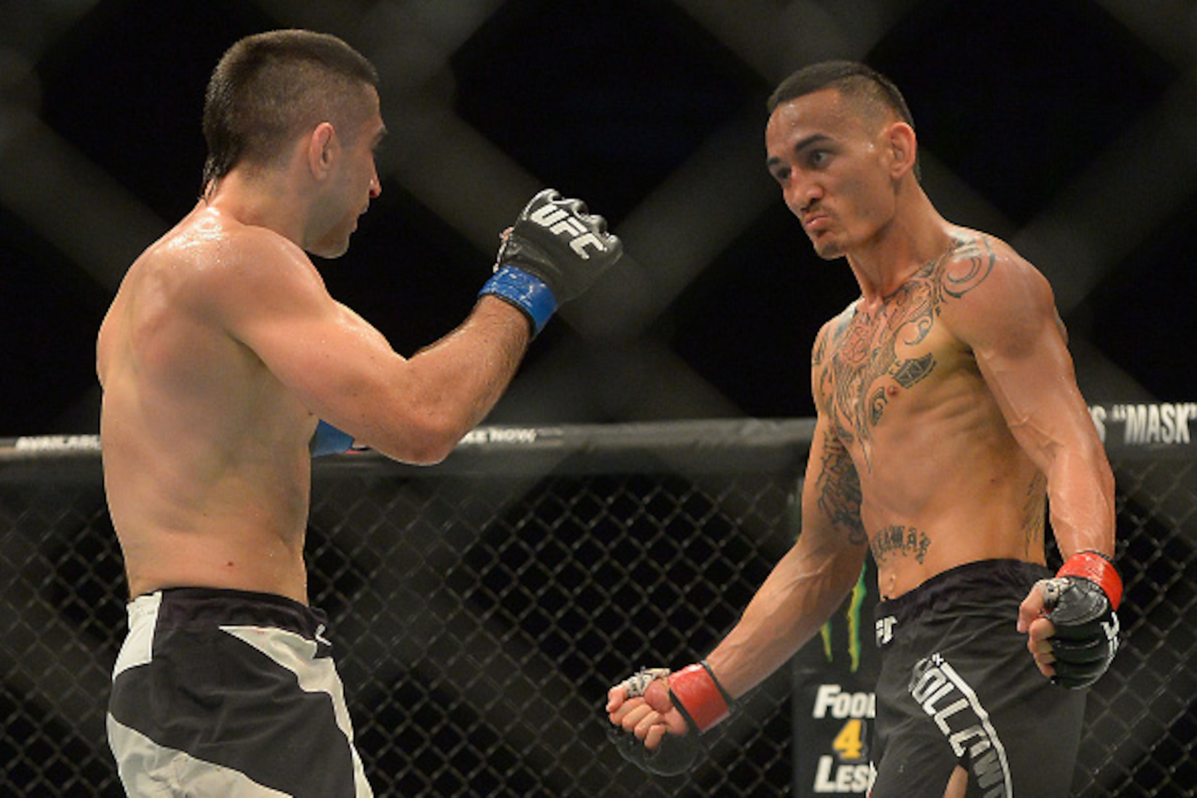 INGLEWOOD, CA - JUNE 04: Ricardo Lamas (blue gloves) and Max Holloway (red gloves) during their featherweight bout at UFC 199 at The Forum on June 4, 2016 in Inglewood, California. (Photo by Jayne Kamin-Oncea/Getty Images)