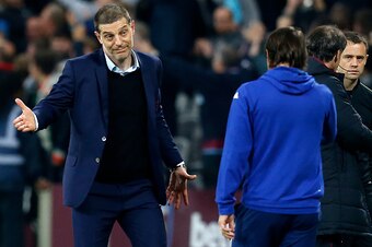 West Ham United's Croatian manager Slaven Bilic (L) gestures to Chelsea's Italian head coach Antonio Conte after the EFL (English Football League) Cup fourth round match between West Ham United and Chelsea at The London Stadium in east London on October 2