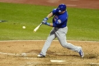 Oct 26, 2016; Cleveland, OH, USA; Chicago Cubs player Kyle Schwarber (12) hits a RBI single against the Cleveland Indians in the third inning in game two of the 2016 World Series at Progressive Field. Mandatory Credit: Tommy Gilligan-USA TODAY Sports