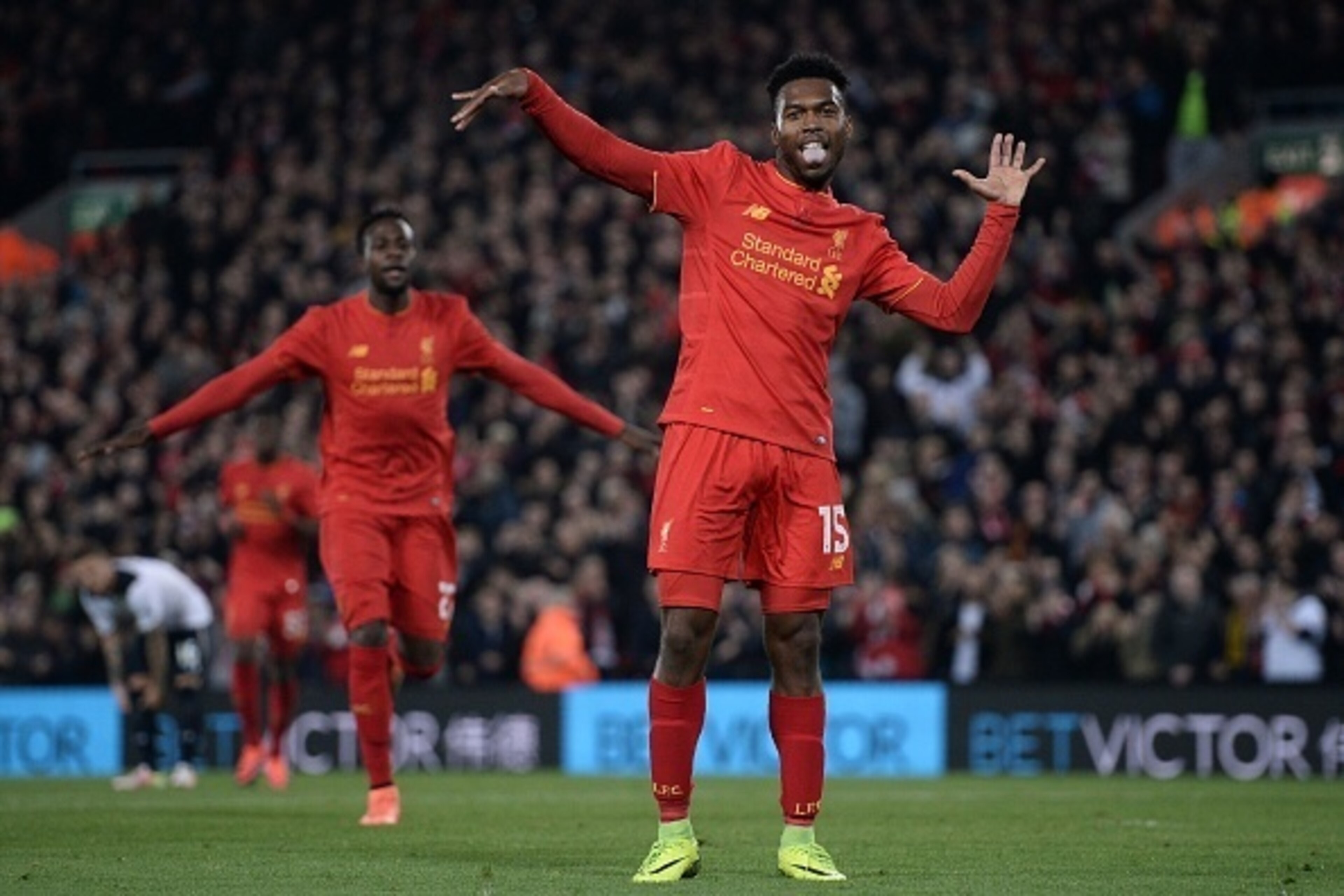 Liverpool's English striker Daniel Sturridge (R) celebrates after scoring their second goal during the EFL (English Football League) Cup fourth round match between Liverpool and Tottenham Hotspur at Anfield in Liverpool north west England on October 25, 2