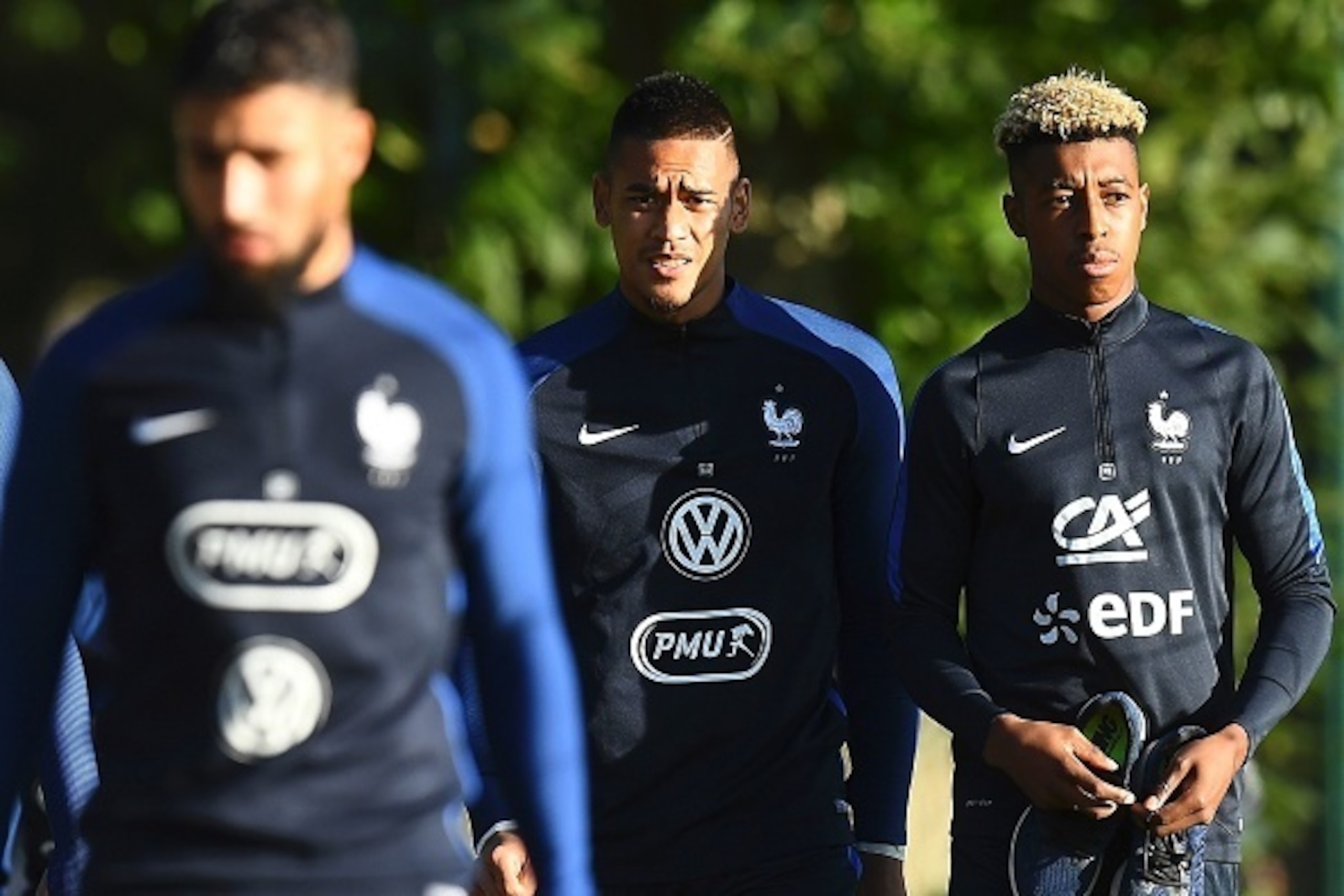 France's defenders Layvin Kurzawa and Presnel Kimpembe (R) arrive for a training session in Clairefontaine-en-Yvelines near Paris on October 4, 2016 ahead of the 2018 FIFA World Cup football matches against Bulgaria on October 7 and the Netherlands on Oct