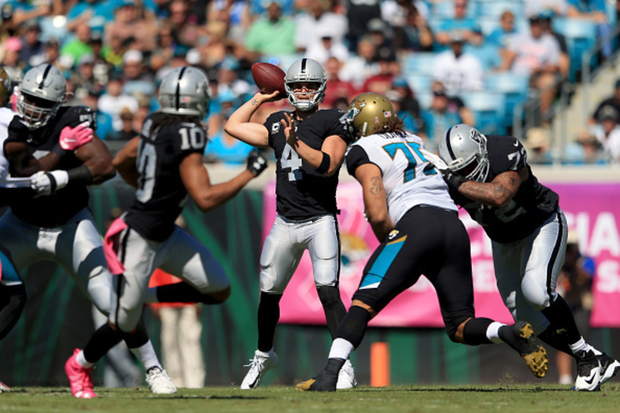 JACKSONVILLE, FL - OCTOBER 23:   Derek Carr #4 of the Oakland Raiders looks to pass against the Jacksonville Jaguars during the game at EverBank Field on October 23, 2016 in Jacksonville, Florida.  (Photo by Rob Foldy/Getty Images)