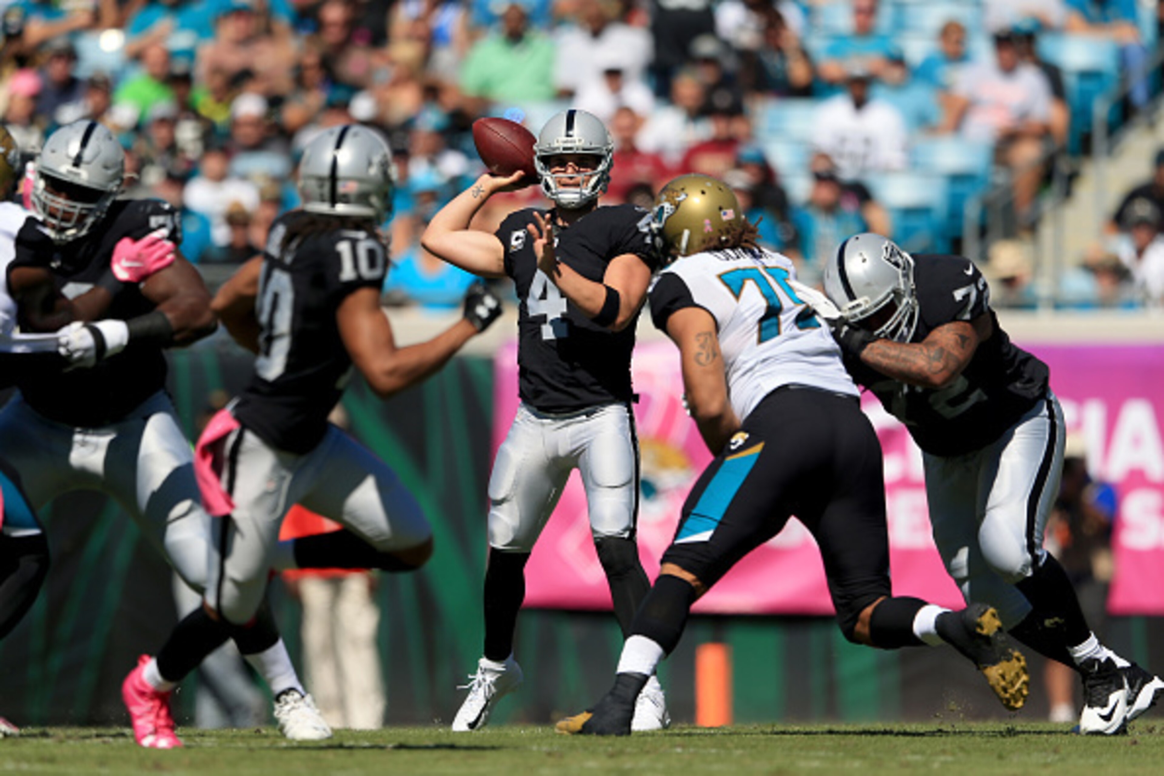 JACKSONVILLE, FL - OCTOBER 23:   Derek Carr #4 of the Oakland Raiders looks to pass against the Jacksonville Jaguars during the game at EverBank Field on October 23, 2016 in Jacksonville, Florida.  (Photo by Rob Foldy/Getty Images)