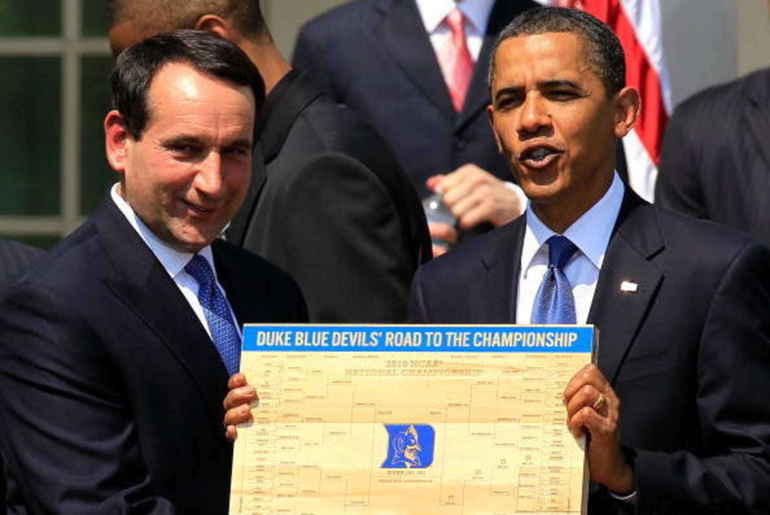 WASHINGTON - MAY 27:  U.S. President Barack Obama (R) is presented with a plaque of a bracket by coach Mike Krzyzewski (L) of the Duke Blue Devils during a Rose Garden event May 27, 2010 at the White House in Washington, DC. Obama hosted the NCAA men bask