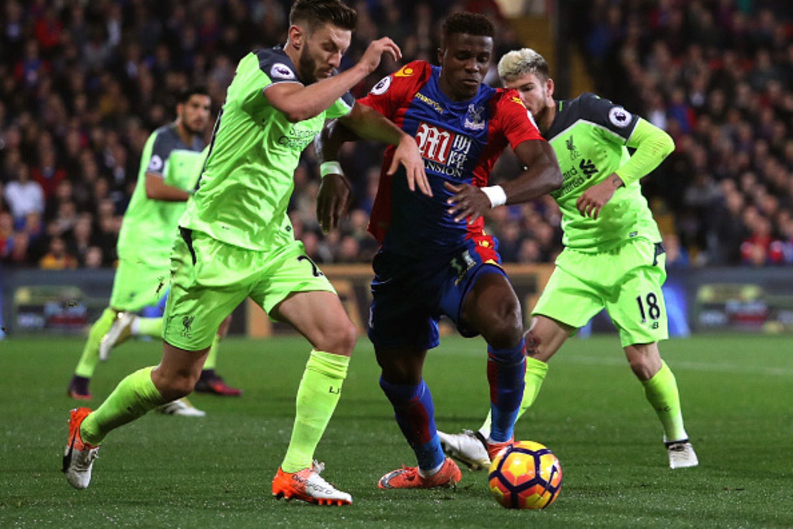 LONDON, ENGLAND - OCTOBER 29: Wilfried Zaha of Crystal Palace holds off pressure from Adam Lallana of Liverpool during the Premier League match between Crystal Palace and Liverpool at Selhurst Park on October 29, 2016 in London, England.  (Photo by Christ
