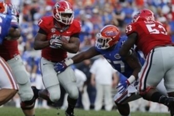Oct 29, 2016; Jacksonville, FL, USA; Georgia Bulldogs running back Nick Chubb (27) runs with the ball as Florida Gators defensive lineman Caleb Brantley (57) defends during the first half at EverBank Field. Mandatory Credit: Kim Klement-USA TODAY Sports