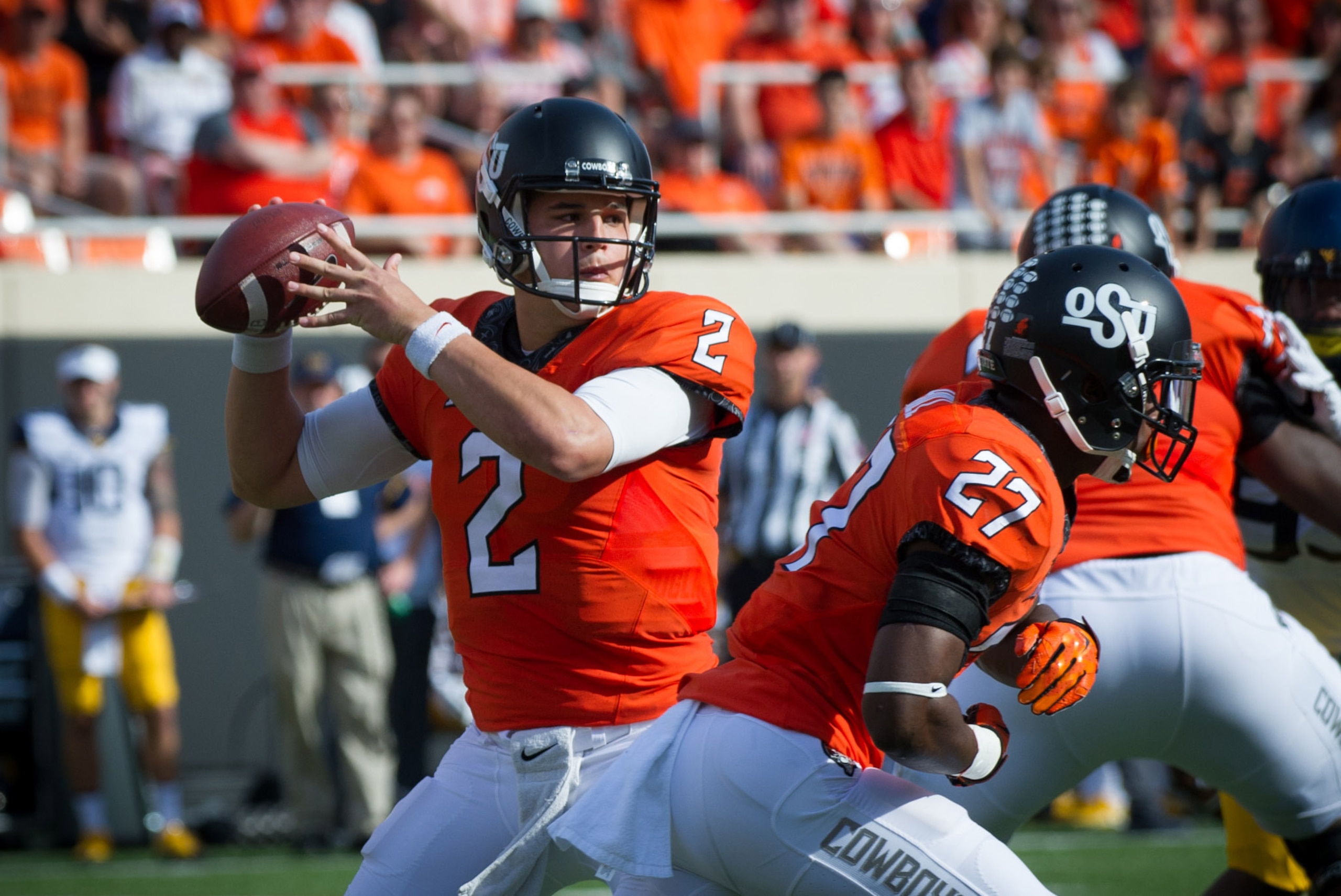 Oct 29, 2016; Stillwater, OK, USA; Oklahoma State Cowboys quarterback Mason Rudolph (2) looks to pass against the West Virginia Mountaineers during the first quarter at Boone Pickens Stadium. Mandatory Credit: Rob Ferguson-USA TODAY Sports