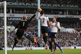 Leicester City's Danish goalkeeper Kasper Schmeichel (L) punches the ball off the head of Tottenham Hotspur's South Korean striker Son Heung-Min during the English Premier League football match between Tottenham Hotspur and Leicester City at White Hart La
