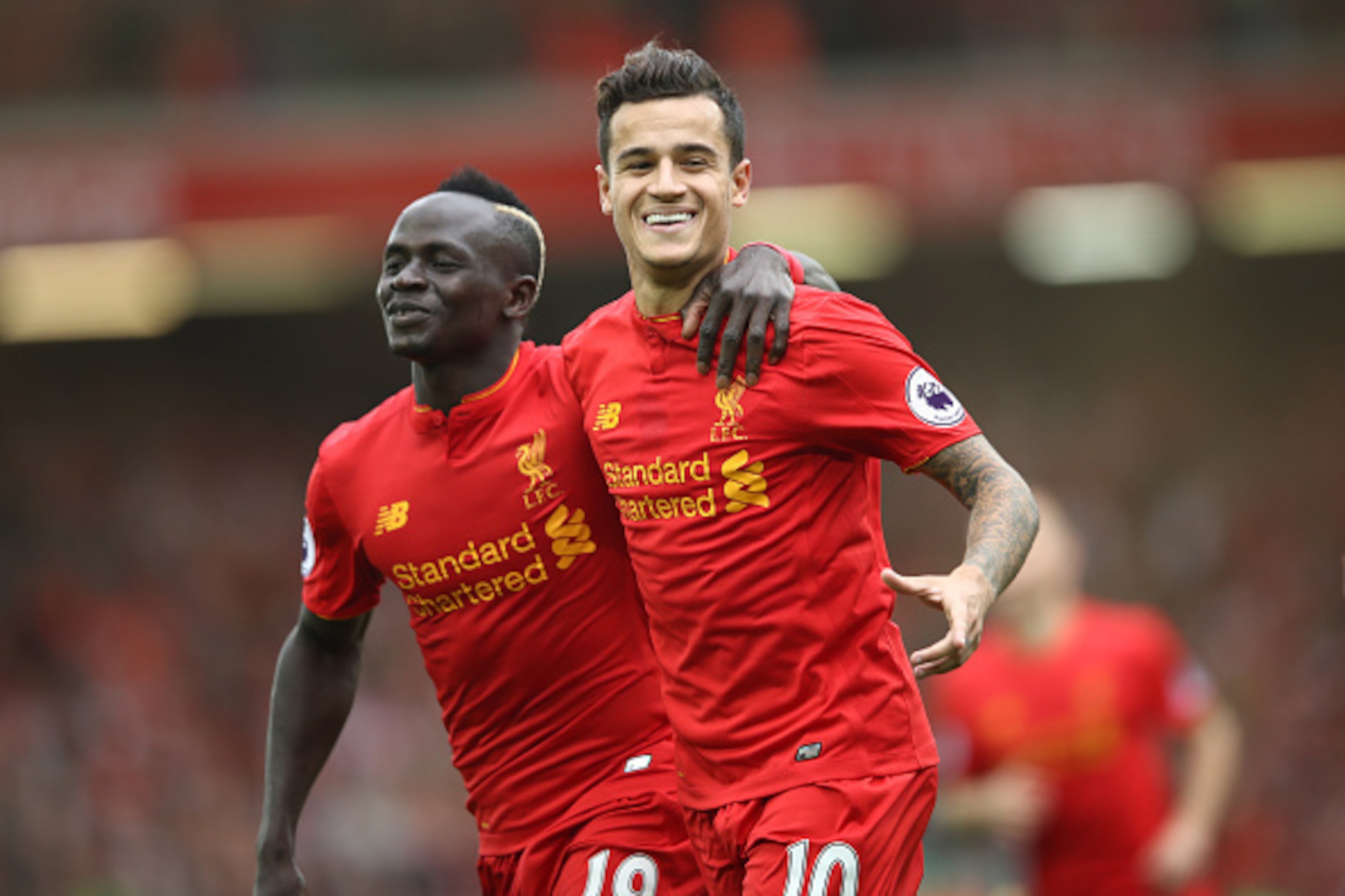 LIVERPOOL, ENGLAND - SEPTEMBER 24:  Philippe Coutinho of Liverpool celebrates with Sadio Mane as he scores their fourth goal during the Premier League match between Liverpool and Hull City at Anfield on September 24, 2016 in Liverpool, England.  (Photo by