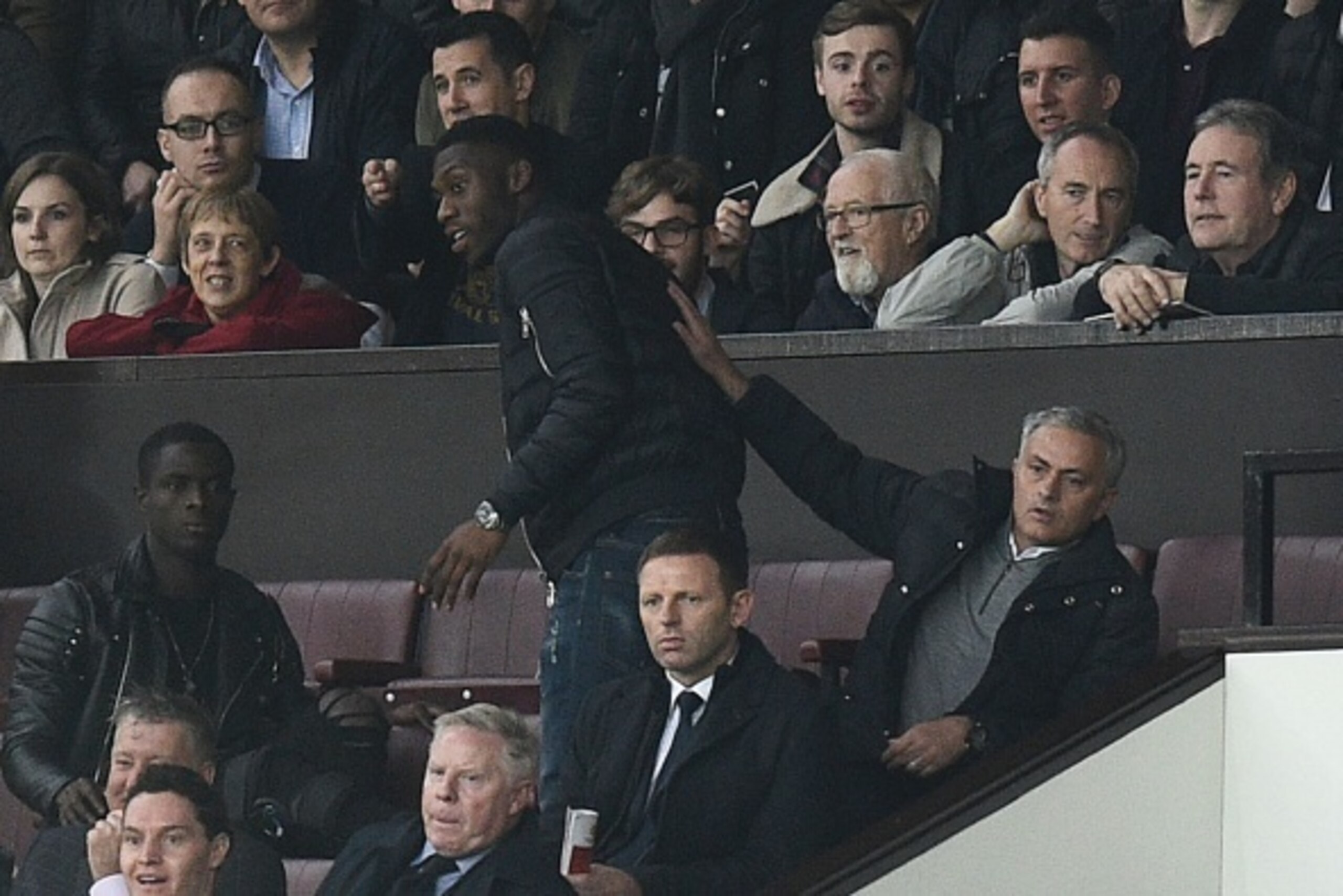 Manchester United's Portuguese manager Jose Mourinho (R) gestures to Manchester United's Dutch defender Timothy Fosu-Mensah (C) as he sits in the Directors Box after being sent off to the stands during the English Premier League football match between Man