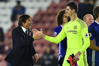 Chelsea's Italian head coach Antonio Conte (L) celebrates with Chelsea's Belgian goalkeeper Thibaut Courtois on the pitch after the English Premier League football match between Southampton and Chelsea at St Mary's Stadium in Southampton, southern England