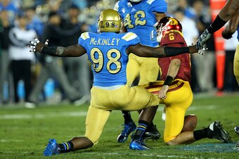 PASADENA, CA - NOVEMBER 22:  Takkarist McKinley #98 of the UCLA Bruins celebrates after sacking quarterback Cody Kessler #6 of the USC Trojans in the third quarter at the Rose Bowl on November 22, 2014 in Pasadena, California.   UCLA on 38-20.  (Photo by 