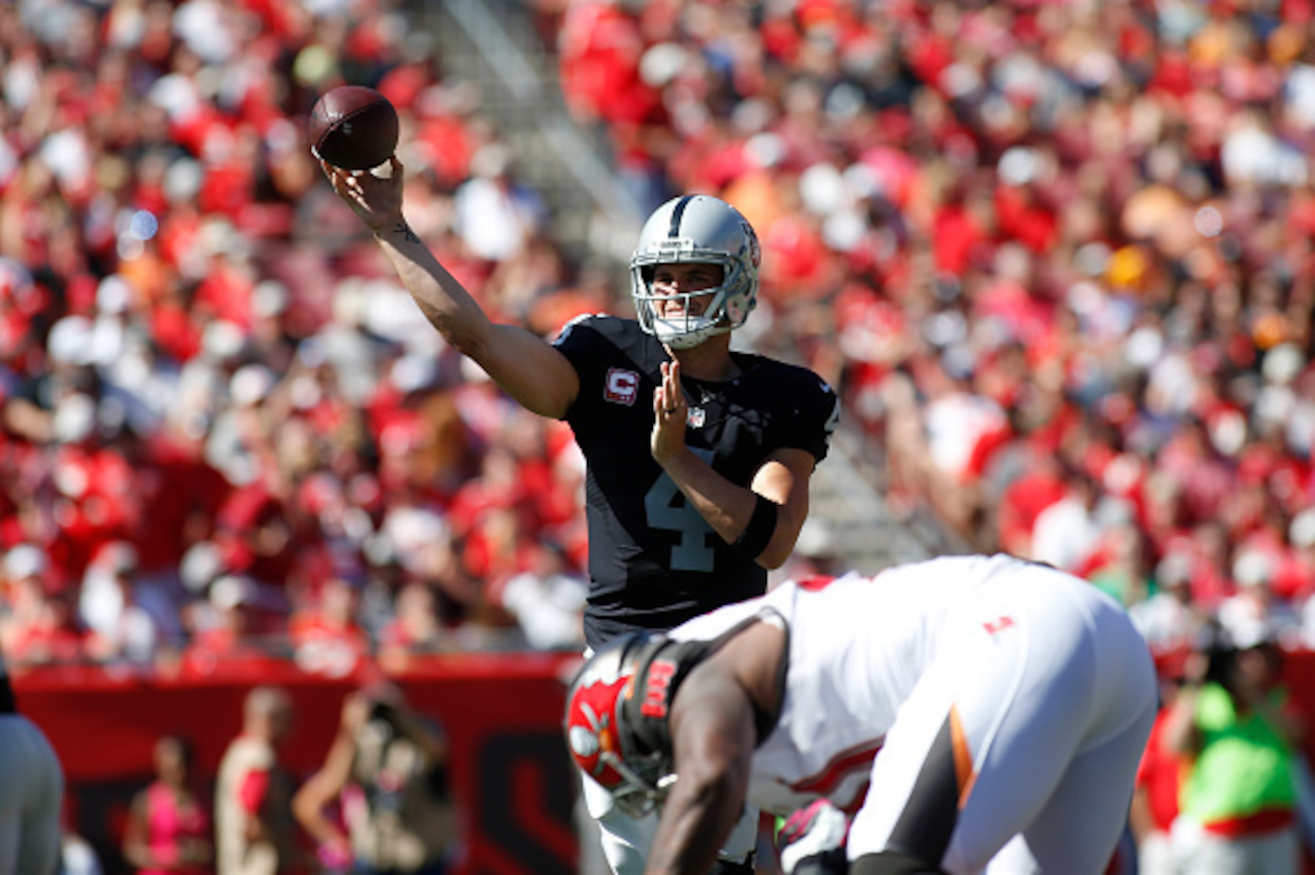TAMPA, FL - OCTOBER 30:  Quarterback Derek Carr #4 of the Oakland Raiders throws to an open receiver during the first quarter of an NFL game against the Tampa Bay Buccaneers on October 30, 2016 at Raymond James Stadium in Tampa, Florida. (Photo by Brian B