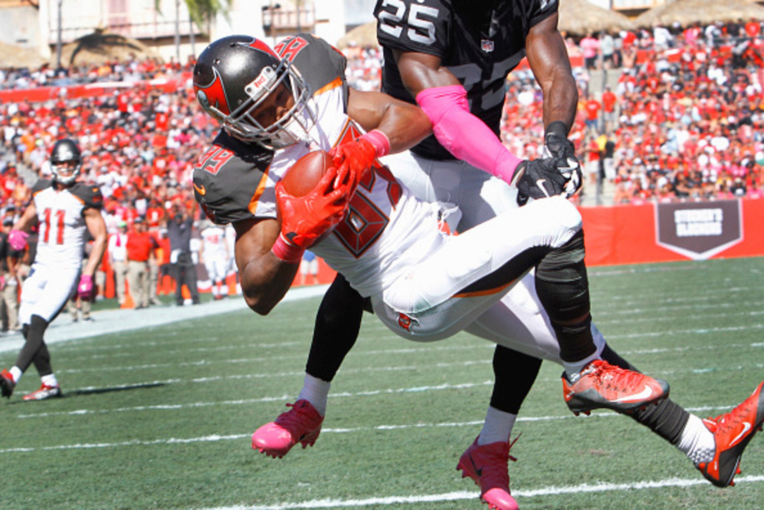 TAMPA, FL - OCTOBER 30: Wide receiver Russell Shepard #89 of the Tampa Bay Buccaneers pulls in the teams first touchdown as cornerback D.J. Hayden #25 of the Oakland Raiders defends during the second quarter at Raymond James Stadium on October 30, 2016 in