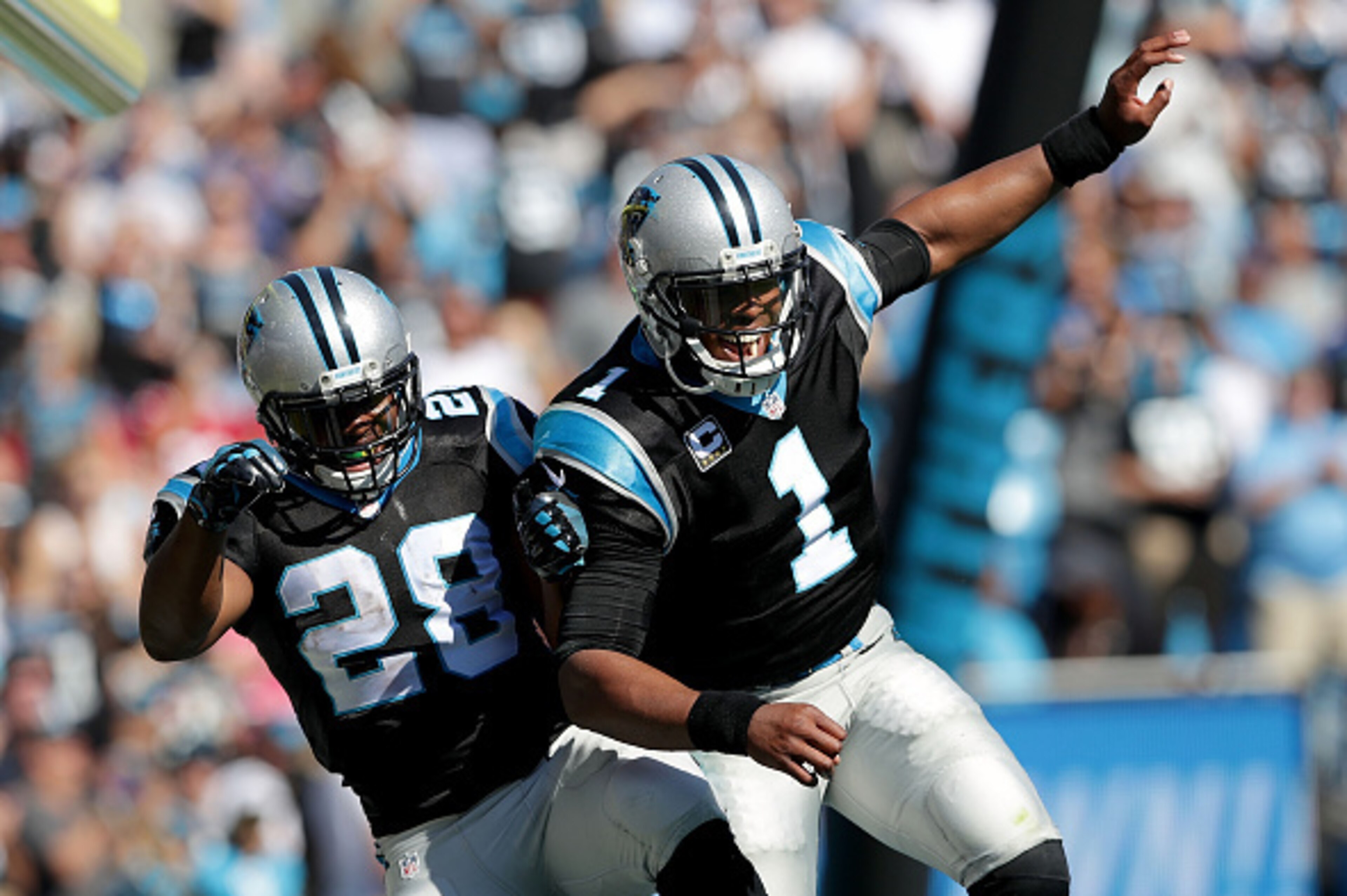 CHARLOTTE, NC - OCTOBER 30:  Teammates Jonathan Stewart #28 and Cam Newton #1 of the Carolina Panthers celebrate after a touchdown against the Arizona Cardinals during their game at Bank of America Stadium on October 30, 2016 in Charlotte, North Carolina.