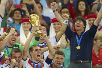 (L-R) Lukas Podolski of Germany, Philipp Lahm of Germany, Thomas Muller of Germany, coach Joachim Low of Germany with world cup trophy during the final of the FIFA World Cup 2014 on July 13, 2014 at the Maracana stadium in Rio de Janeiro, Brazil.(Photo by