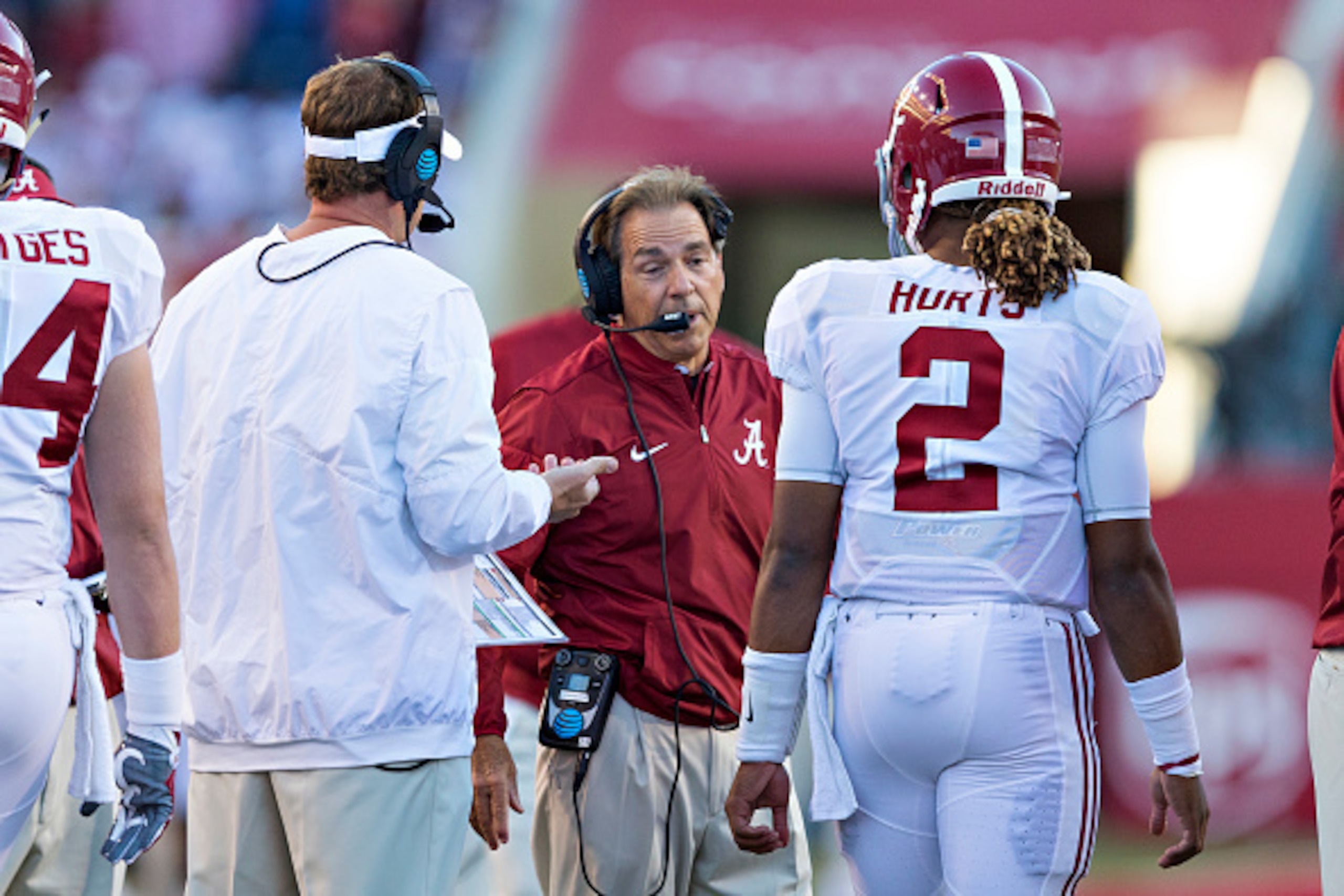 FAYETTEVILLE, AR - OCTOBER 8:  Head Coach Nick Saban talks with Lane Kiffin and Jalen Hurts #2 of the Alabama Crimson Tide during a game against the Arkansas Razorbacks at Razorback Stadium on October 8, 2016 in Fayetteville, Arkansas.  The Crimson Tide d