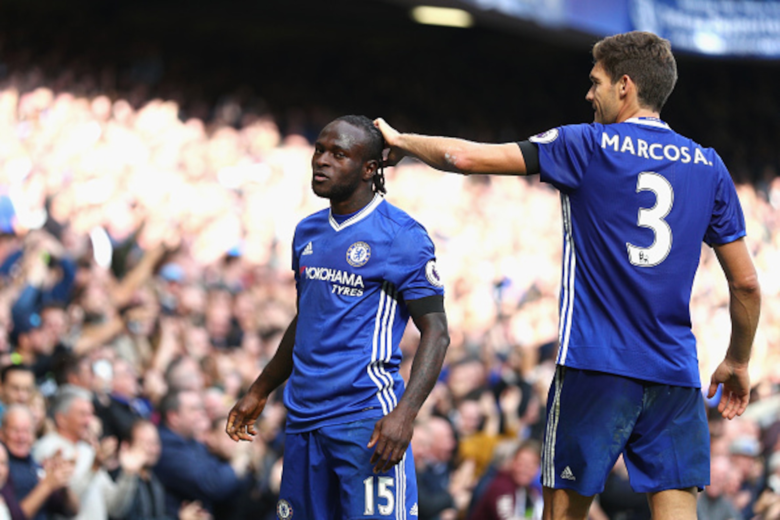 LONDON, ENGLAND - OCTOBER 15: Victor Moses of Chelsea (L) celebrates scoring his sides third goal with Marcos Alonso of Chelsea (R) during the Premier League match between Chelsea and Leicester City at Stamford Bridge on October 15, 2016 in London, Englan