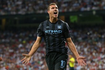 MADRID, SPAIN - SEPTEMBER 18:  Edin Dzeko of Manchester City FC celebrates after scoring the opening goal during the  UEFA Champions League Group D match between Real Madrid and Manchester City FC at Estadio Santiago Bernabeu on September 18, 2012 in Madr