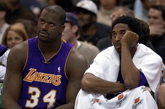 WASHINGTON, :  Los Angeles Lakers' center Shaquille O'Neal (L) and teammate Kobe Bryant (R) watch the game against the Washington Wizards in the fourth quarter 16 March 2001 at the MCI Center in Washington, DC. The Lakers beat the Wizards 101-89.  AFP PHO