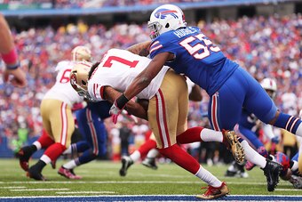 BUFFALO, NY - OCTOBER 16:   Colin Kaepernick #7 of the San Francisco 49ers is almost tackled for a safety by Jerry Hughes #55 of the Buffalo Bills during the second half at New Era Field on October 16, 2016 in Buffalo, New York.  (Photo by Brett Carlsen/G
