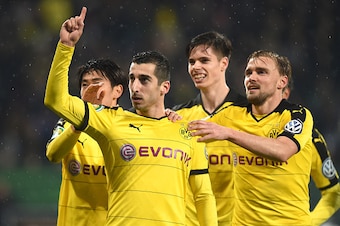 Dortmund's Armenian midfielder Henrikh Mkhitaryan (2ndL)and teammates celebrate after a second goal during the German Cup DFB Pokal third round match between Borussia Dortmund and FC Augsburg in Augsburg on December 16, 2015.  / AFP / Christof STACHE / RE