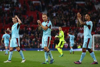 MANCHESTER, ENGLAND - OCTOBER 29: (L to R) Jon Flanagan, Scott Arfield and Andre Gray of Burnley applaud supporters after their team's scoreless draw in the Premier League match between Manchester United and Burnley at Old Trafford on October 29, 2016 in 