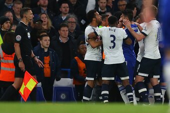 LONDON, ENGLAND - MAY 02 :  The assistant referee watches as Diego Costa of Chelsea holds his face after he clashes with Mousa Dembele of Tottenham Hotspur during the Barclays Premier League match between Chelsea and Tottenham Hotspur at Stamford Bridge o