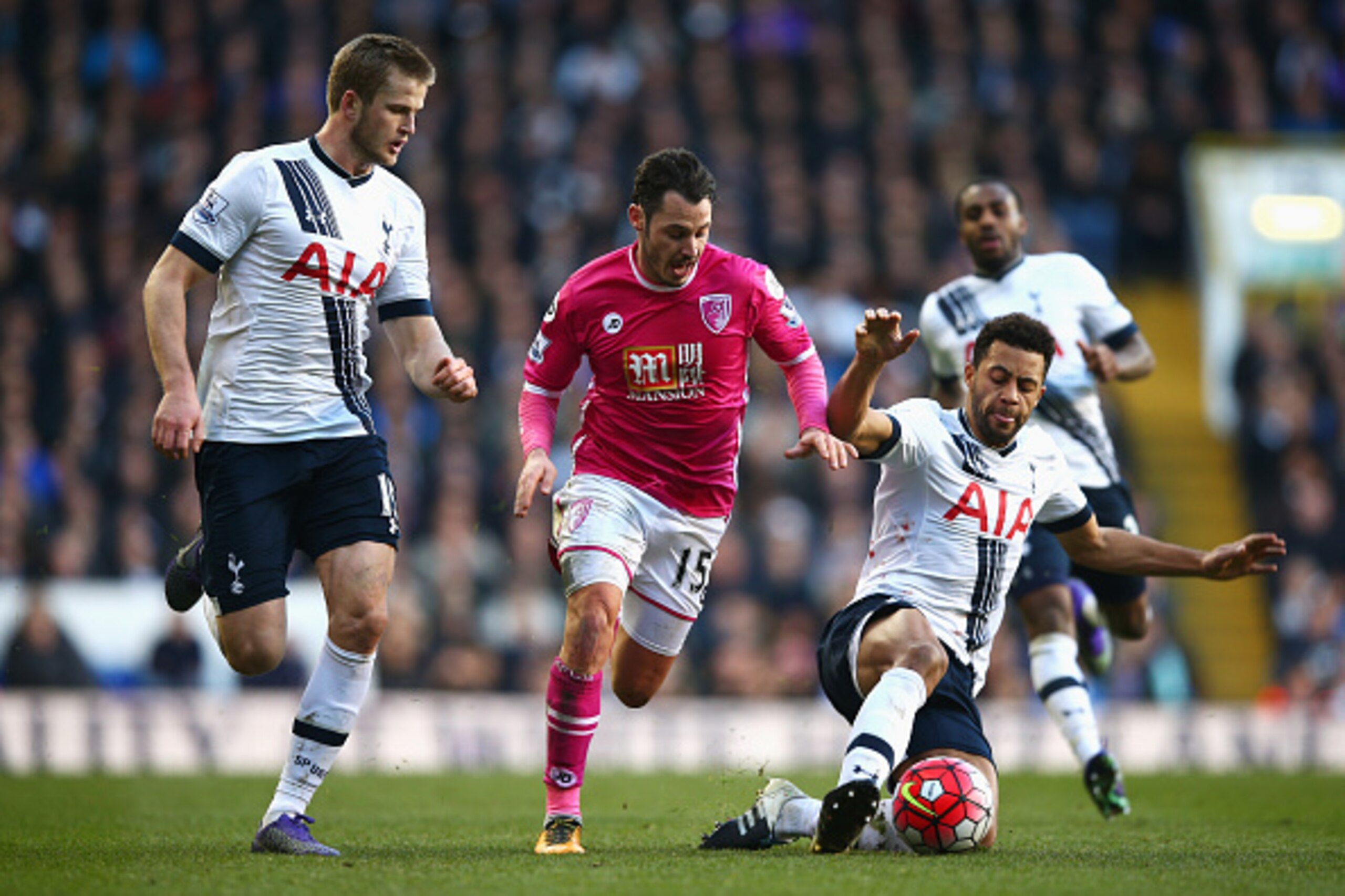 LONDON, ENGLAND - MARCH 20:  Adam Smith of Bournemouth attempts to beat Mousa Dembele (R) and Eric Dier of Tottenham Hotspur (L) during the Barclays Premier League match between Tottenham Hotspur and A.F.C. Bournemouth at White Hart Lane on March 20, 2016