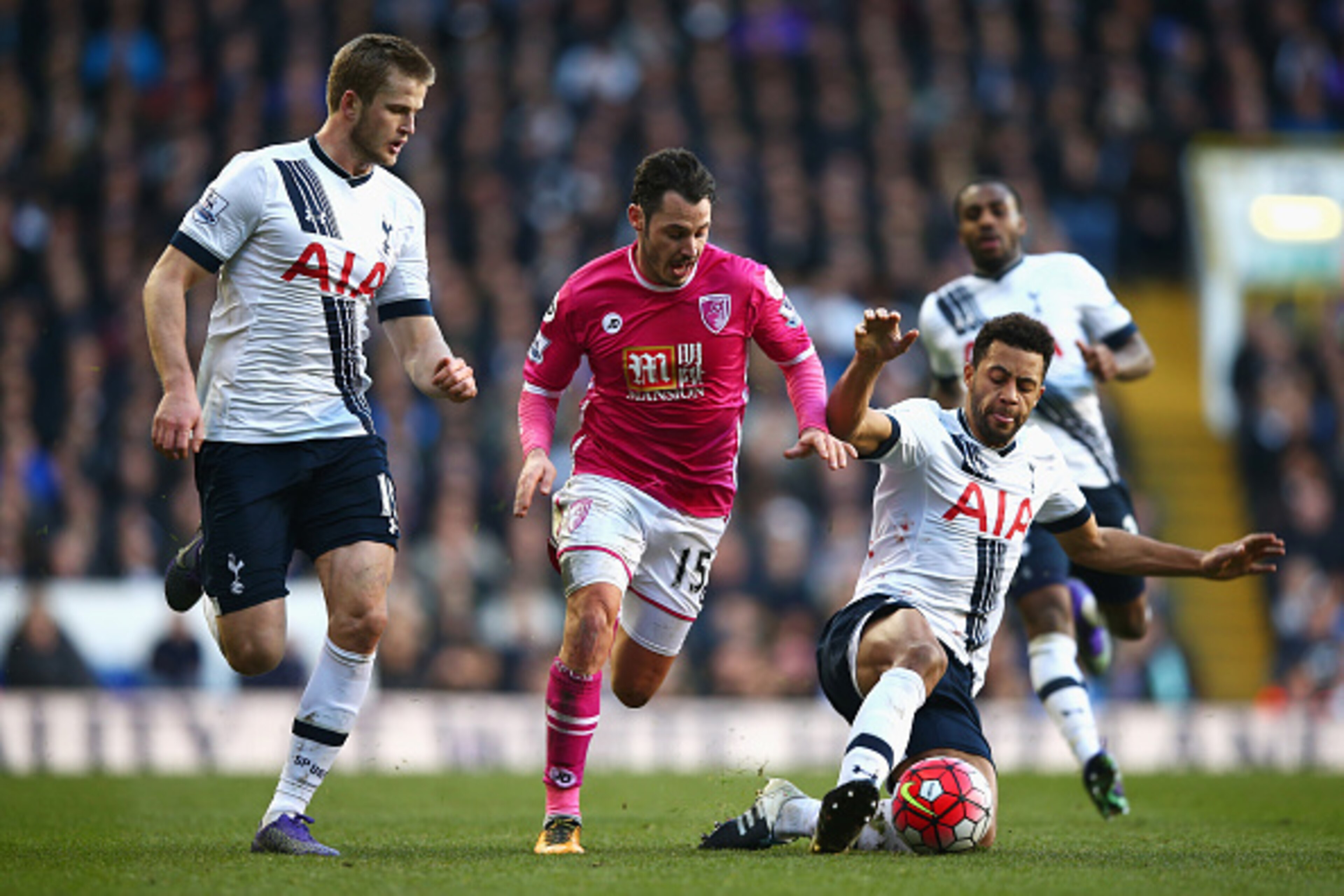 LONDON, ENGLAND - MARCH 20: Adam Smith of Bournemouth attempts to beat Mousa Dembele (R) and Eric Dier of Tottenham Hotspur (L) during the Barclays Premier League match between Tottenham Hotspur and A.F.C. Bournemouth at White Hart Lane on March 20, 2016 LONDON, ENGLAND - MARCH 20: Adam Smith of Bournemouth attempts to beat Mousa Dembele (R) and Eric Dier of Tottenham Hotspur (L) during the Barclays Premier League match between Tottenham Hotspur and A.F.C. Bournemouth at White Hart Lane on March 20, 2016