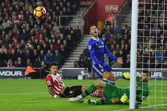 Chelsea's Belgian midfielder Eden Hazard (C) reacts after Southampton's Portuguese defender Jose Fonte (L) got his boot to the ball to deflect a cross during the English Premier League football match between Southampton and Chelsea at St Mary's Stadium in