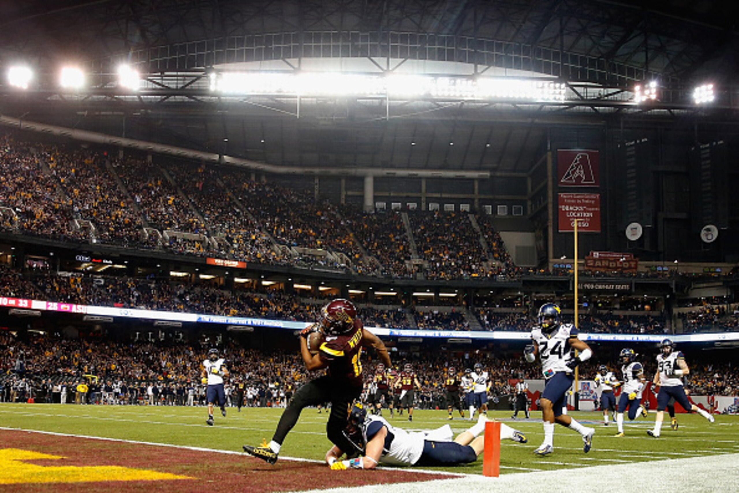 PHOENIX, AZ - JANUARY 02:  Wide receiver Tim White #12 of the Arizona State Sun Devils scores a 33 yard touchdown reception against the West Virginia Mountaineers during the third quarter of the Motel 6 Cactus Bowl at Chase Field on January 2, 2016 in Pho